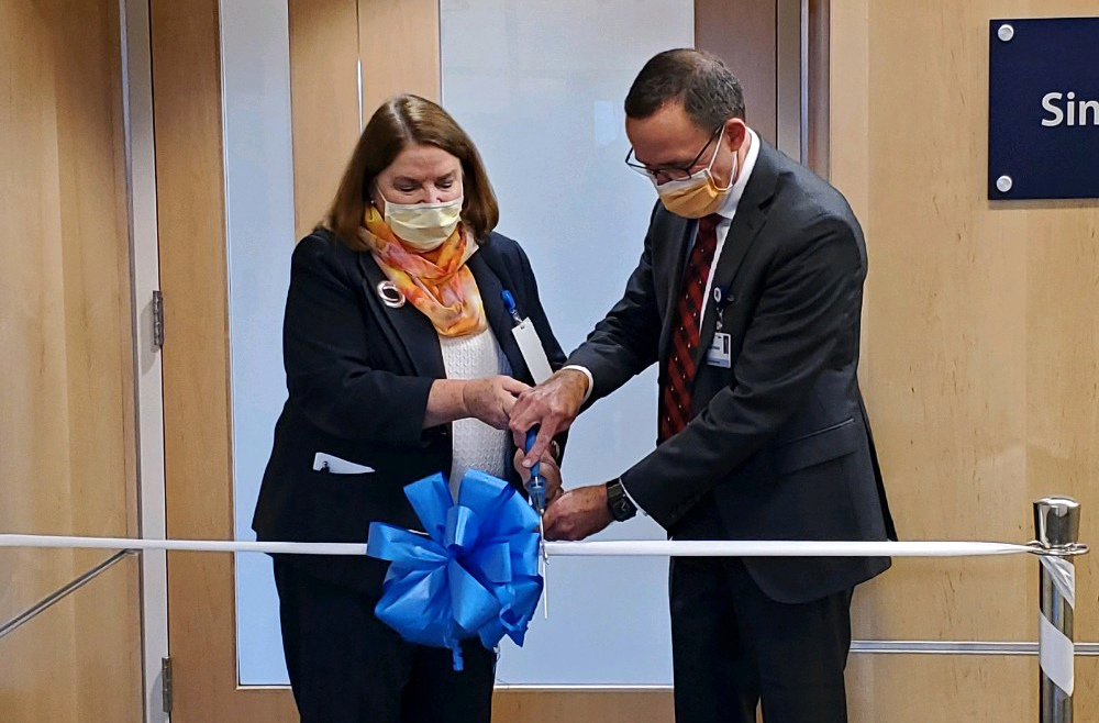 Sheila Kempf, RN, PhD, vice president of patient care services/chief nursing officer (left), and Princeton Health CEO James Demetriades cut the ribbon on a new 1,760-square-foot simulation and training lab at Princeton Medical Center. 